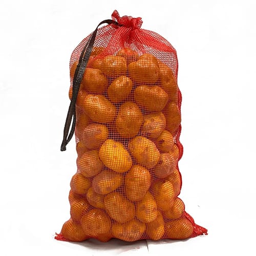 Red PP Leno mesh bag filled with citrus fruit